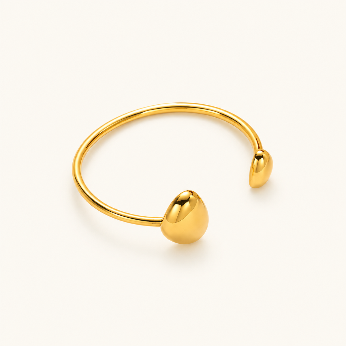 Brazalete de mujer con diseño abierto y extremos en forma de gota