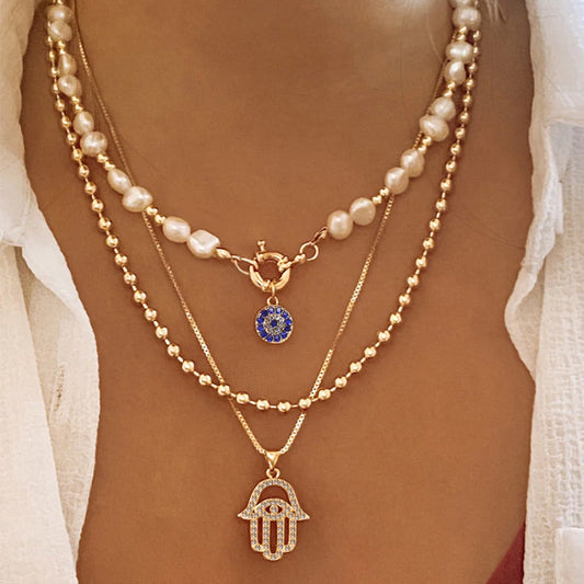 Jade – Collar Multi-niveles Perla & Hamsa